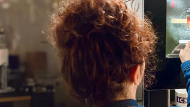 woman using touchscreen coffeemaker